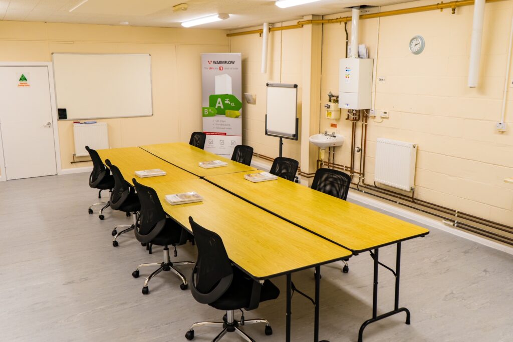 Classroom with ACS books on desk and oil banner in the background