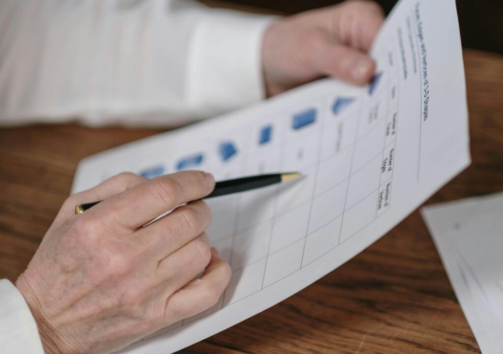 male hands with a pen writing Auditing Solutions for a client
